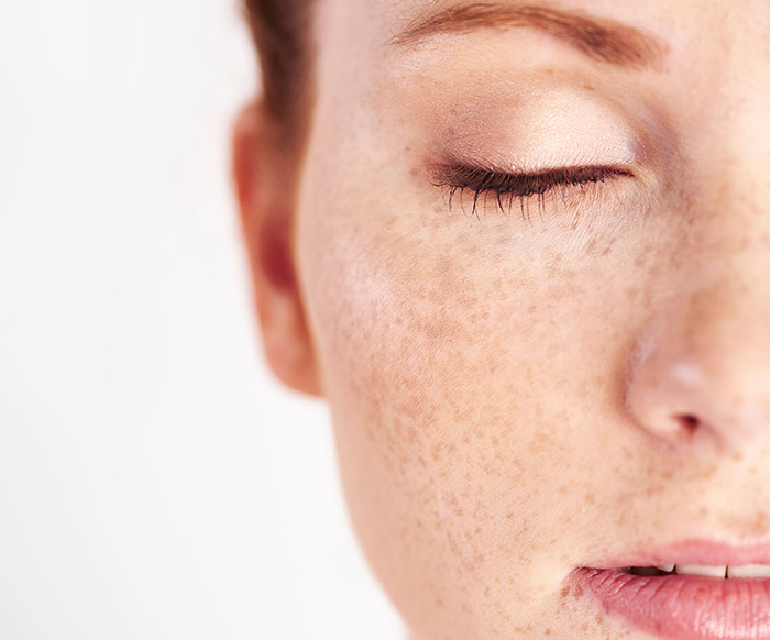 Close up of a fair skin toned ginger womans face