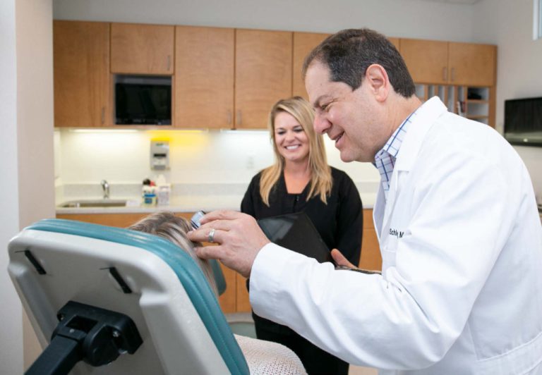 Dr. Joel Schlessinger Inspecting a patient