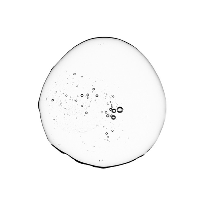 Close of of a clear drop of Salicylic Acid on white background