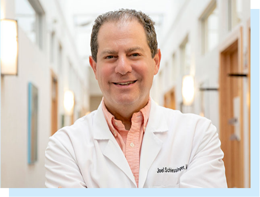 Profile of Dr. Joel Schlessinger in lab coat standing in a hallway inside Schlessinger MD office